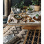 Organic, non-toxic, sustainable dining table display with woven table runners, wooden bowls, fresh salad, and plants.